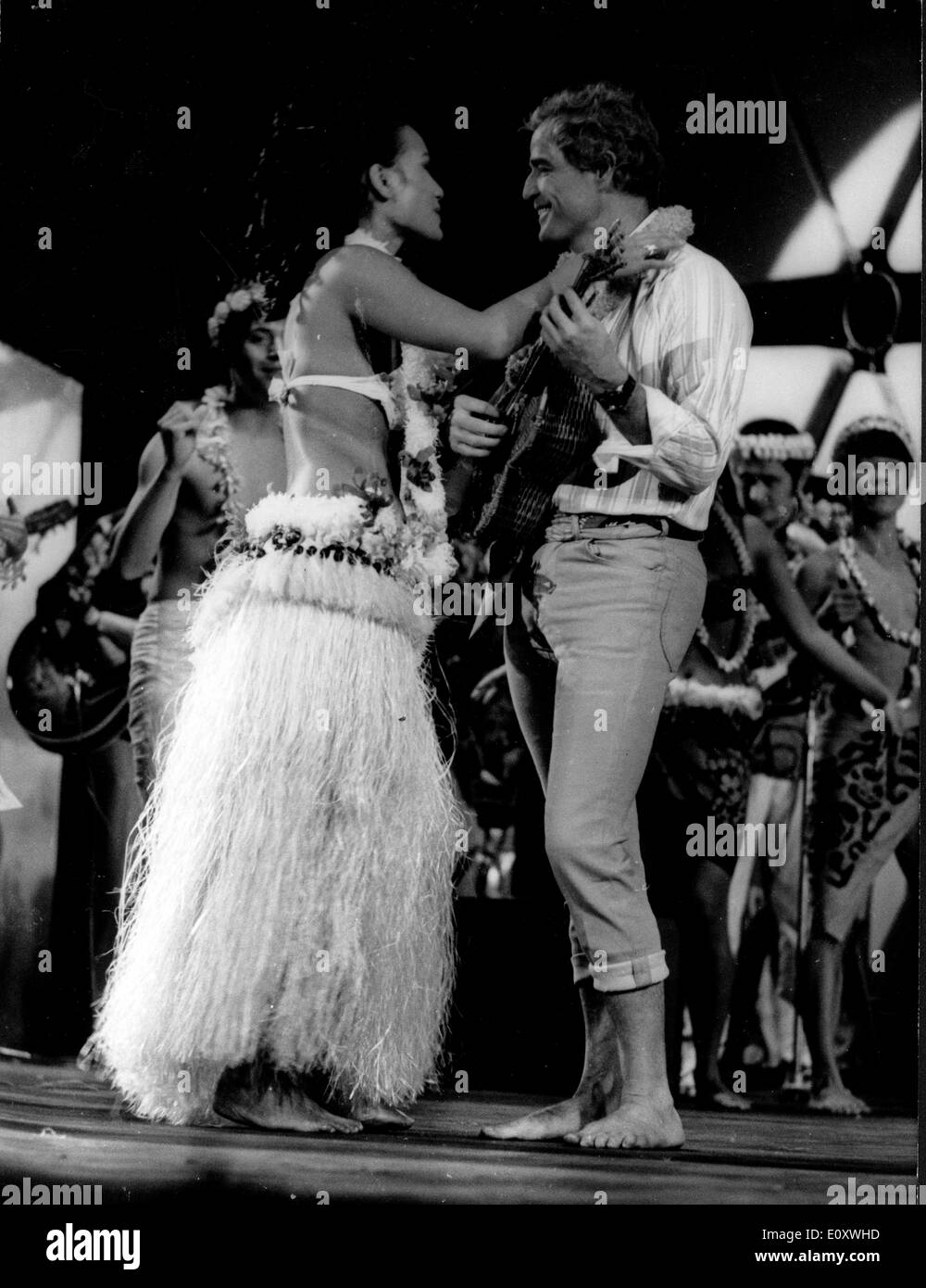 Actor Marlon Brando dancing with a hula girl at a UNICEF Gala Stock Photo