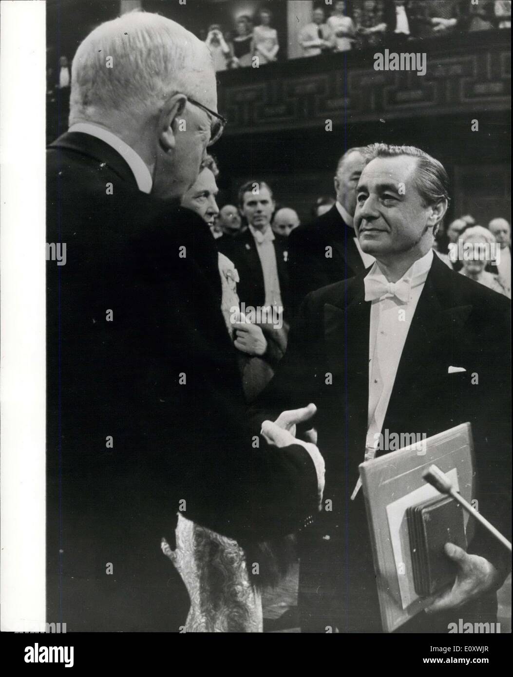 Dec. 12, 1967 - Nobel Prize Awards in Stockholm: At a ceremony in the Concert Hall, Stockholm, on Sunday (Dec 10), King Gustav Adolf of Sweden, presented this year's Nobel Prizes. The ceremony was held on the 71st. Anniversary of the death of Alfred Nobel, the inventor and industrialist, Photo shows Prof. George Porter ( Britain), joint winner of the prize for chemistry - receiving the prize from King Gustav Adolf of Sweden. Stock Photo