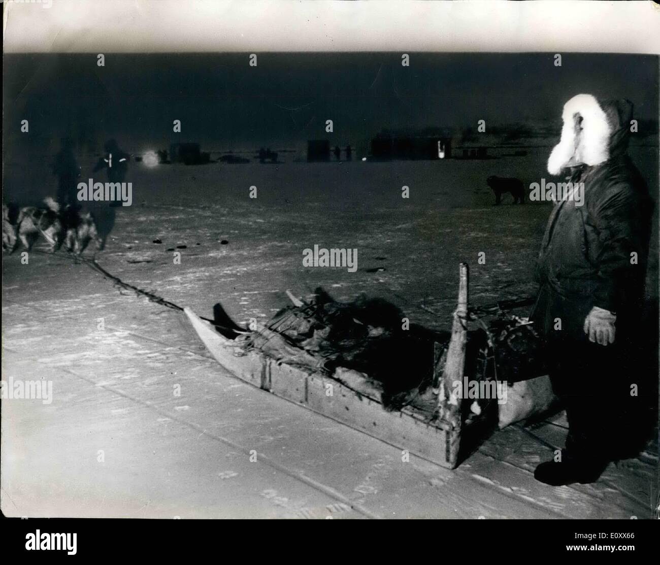 Jan. 01, 1968 - Search at Site Of Crashes B.52 Bomber IN Green land: Picture Shows: Workers shown with an Eskimo dog team in Arctic Circle Twilight, on the ice where the American B-52 bomber crashed near Thule air base in Greenland on January 21, with four H-bombs. The buildings seen are temporary structures for recovery teams. Stock Photo