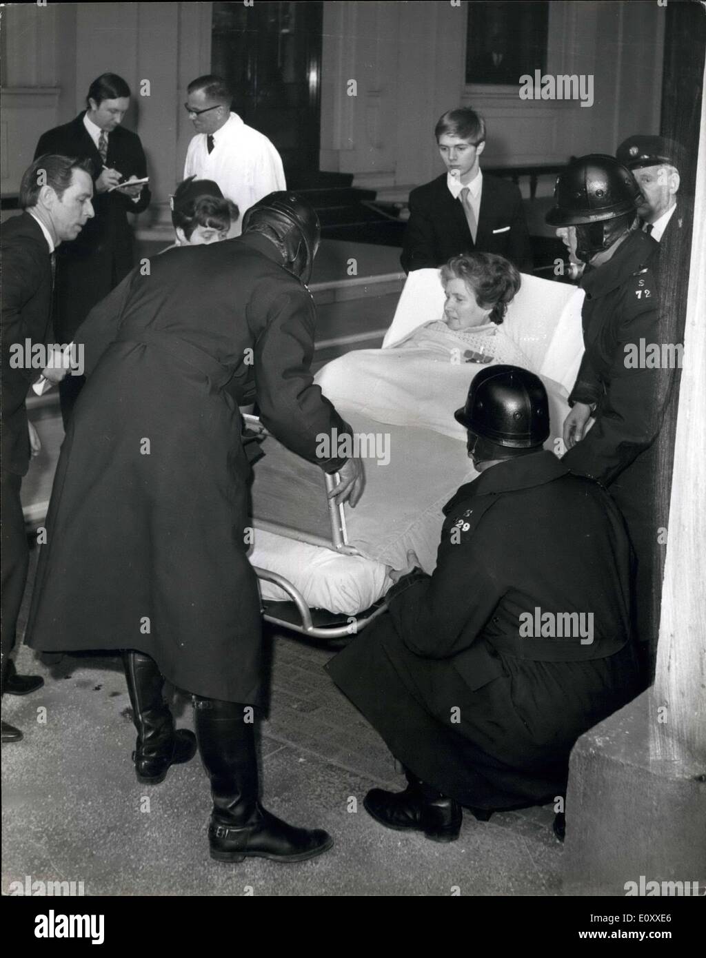 Mar. 12, 1968 - March 12, 1968 Mrs. Doris Page receives the MBE. Police motorcyclist lift the bed carrying Mrs. Doris Page, 42, from the ambulance to the ground in the quadrangle of Buckingham Palace today. Mrs. page who is a polio victim and uses an iron lung, was wheeled into the Bow Room of the Palace to receive the MBE from Queen Elizabeth II for her work as editor of the magazine Responaut for people living by breathing apparatus. Mrs. Page's husband, Kenneth is pictured at the foot of the bed (left) and one of her two sons is pictured at the head of the bed. Stock Photo