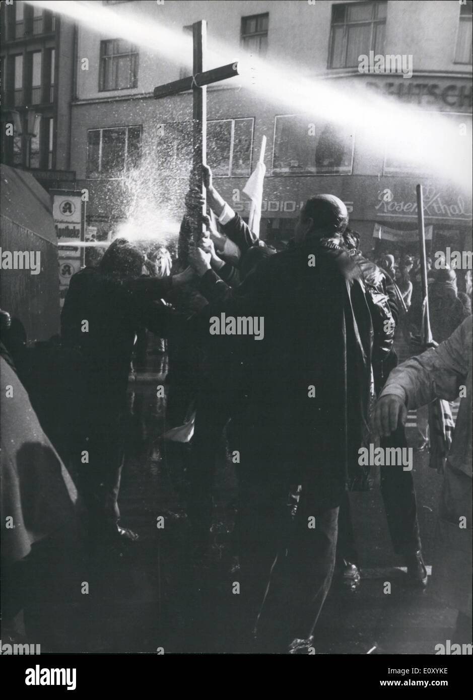 Apr. 04, 1968 - Heavy demonstrations in Berlin: On Sunday 14-04-68 the heavy demonstration in Berlin against the attempt on Rudi Dutschke went on. Sometime the police was loosing the control, when street-battles took place on the Kurfurstendamm. 1.) Behind a cross the demonstrators went against a water-canon. Stock Photo