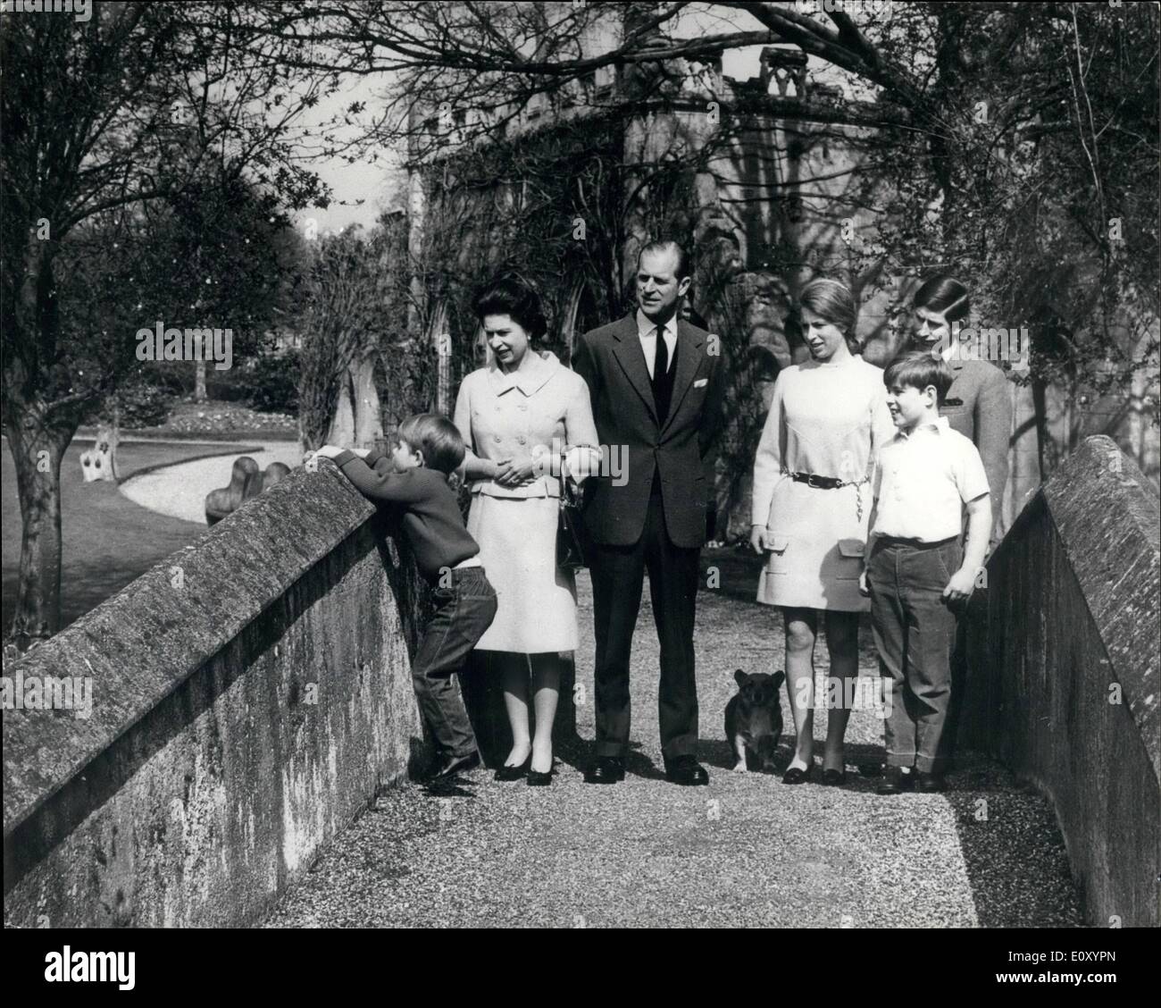 Apr. 04, 1968 - Inquisitive Prince: Happy birthday picture for Queen Elizabeth II, who is 42 today (Sunday), but it was four-year old Prince Edward who stole the scene here by reaching up to peep over the bridge as the Royal Family posed for a birthday group in the grounds of Fregmore, Windsor. And what mother wouldn't be happy to see her boisterous son demonstrating his healthy tomboyish pranks. Also seen with The Queen are The Duke Of Edinburgh (47 in June), Princess Anne (18 in August), The Prince Of Wales, 19 and Prince Andrew, 8. The family would not be complete without the pet corgi. Stock Photo