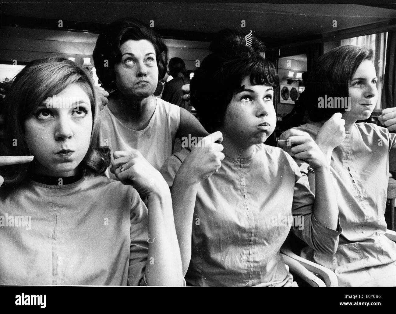 Women making faces at beauty salon Stock Photo
