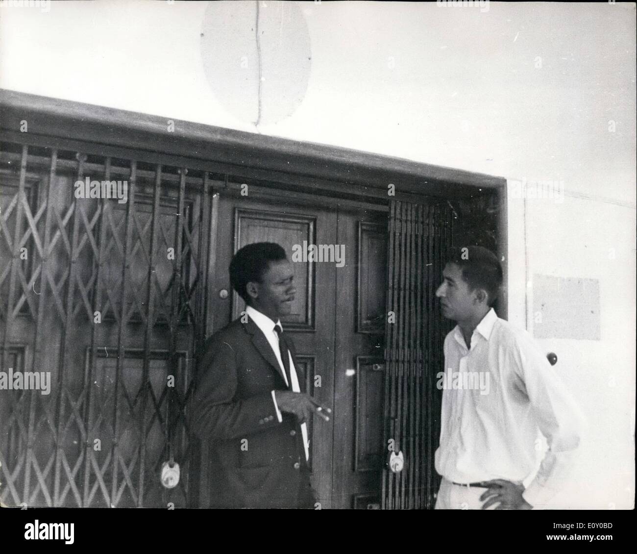 Apr. 23, 1968 - April 23, 1968 Embassies close and open in Dar Es Salaam. In Dar es Salaam on Sunday, the Nigerian Embassy was closed, and the Biafrans were preparing to open an embassy. Photo Shows: The first Secretary of the Nigerian Embassy to Tanzania, Mr. Hamza Munamnadu, (wearing a suit) pictured with a friend outside the main embassy door just before closing it in Dar es Salaam on Sunday. Stock Photo