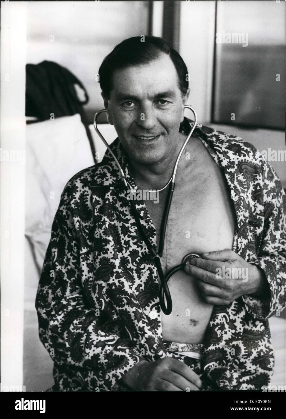 May 05, 1968 - Listening to his new heart.: Mr. Fred West, 45, of Leigh-on-sea, British's first heart transplant patient, showing his stitched-up chest, listens to the beat of his new heart at the National Heart Hospital, Marylebone, London, today. Yesterday, Mr. West was moved from the theatre where the operation took place three weeks and three days ago, into his own hospital suite. Mr. West received the heart of Irish-born carpenter. Mr. Patrick Ryan,26, who died following a fall from a building site. Stock Photo