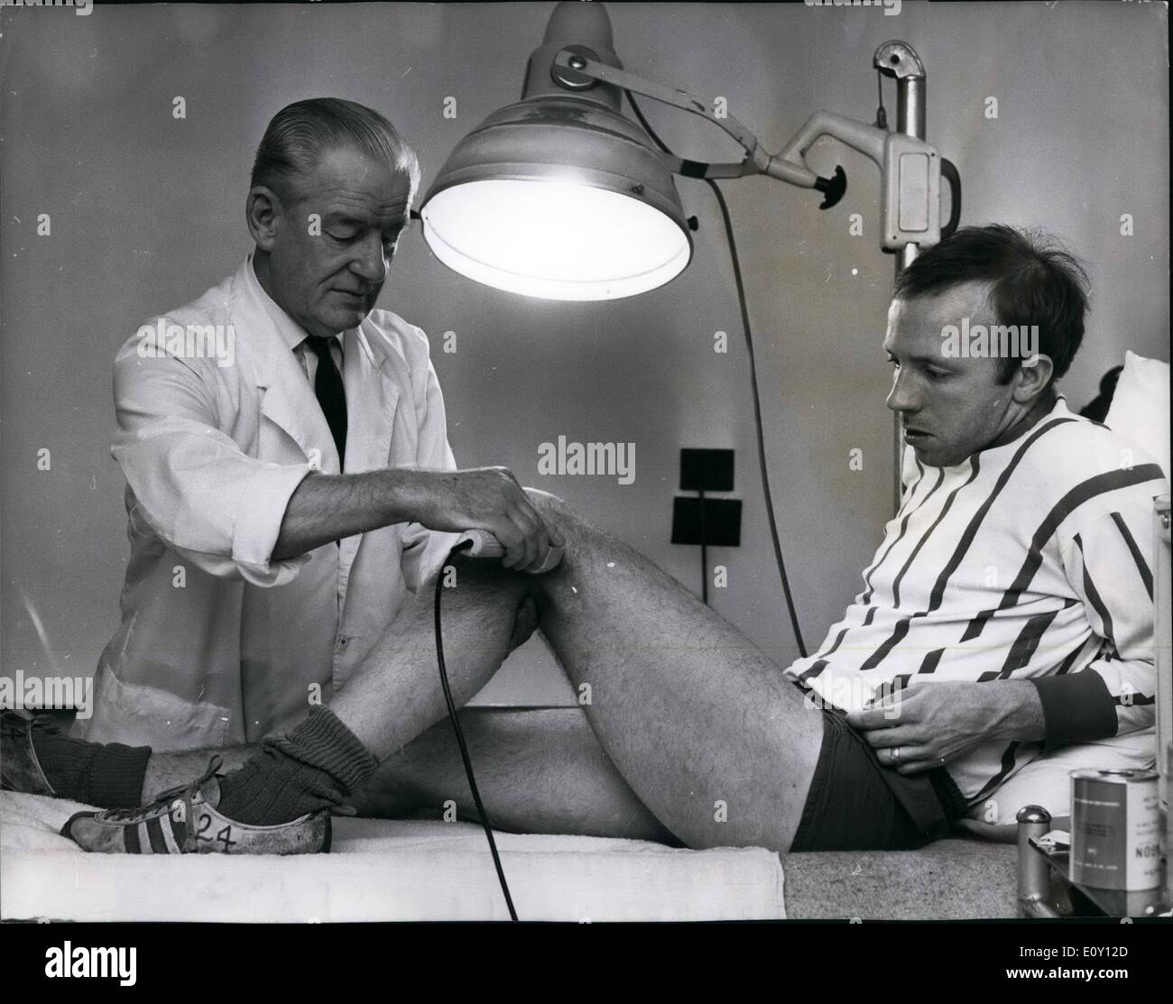 May 05, 1968 - Nobby Stiles leg looks like being ready in time for European cup final; That very important knee of Manchester United's Nobby Stiles looks like ready in time for their European Cup Final against Benfica at Wembley next Wednesday. That according to Nobby and club's physiotherapist Ted Dalton, who is seen here giving the knees some local attention. ''Its doing fine,'' said Ted, ''but he's not running on it yet Stock Photo