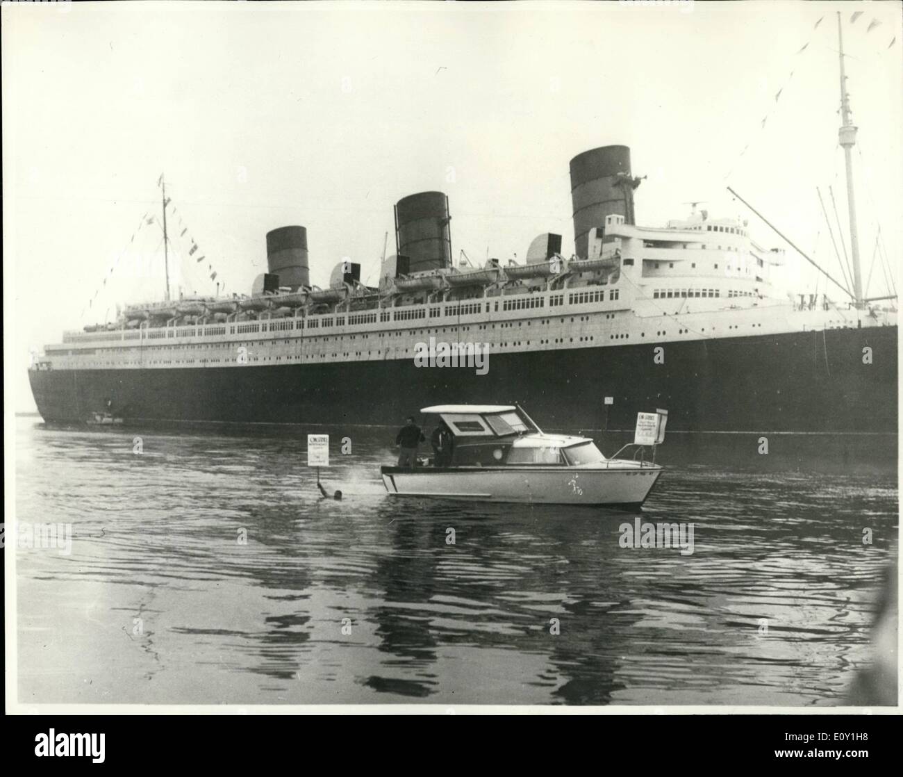 Mar. 03, 1968 - Queen Mary Strike Bound at Long Beach. None of the Queen Mary's countless Atlantic crossings has been more storm tossed than the 1 1/2 mile trip she is trying to make from her present mooring at Long Beach to a nearby drydock. Various maritime unions dispute the right to land based unions to work aboard the Queen Mary during her conversion to a maritime museum and convention centre. When she does finally reach drydock the famous 80,000 ton vessel will be laid up for six weeks having three of her four screws removed and her keel sand blasted Stock Photo