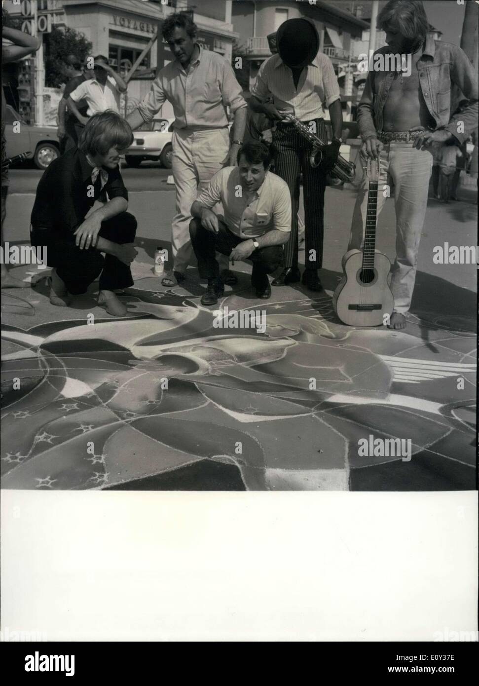 Sep. 14, 1968 - Surrounded by Beatniks and Hippies, Raymond Moretti draws on the sidewalk. A renowned artist, he abandoned his luxury studio to paint on the sidewalk. Stock Photo