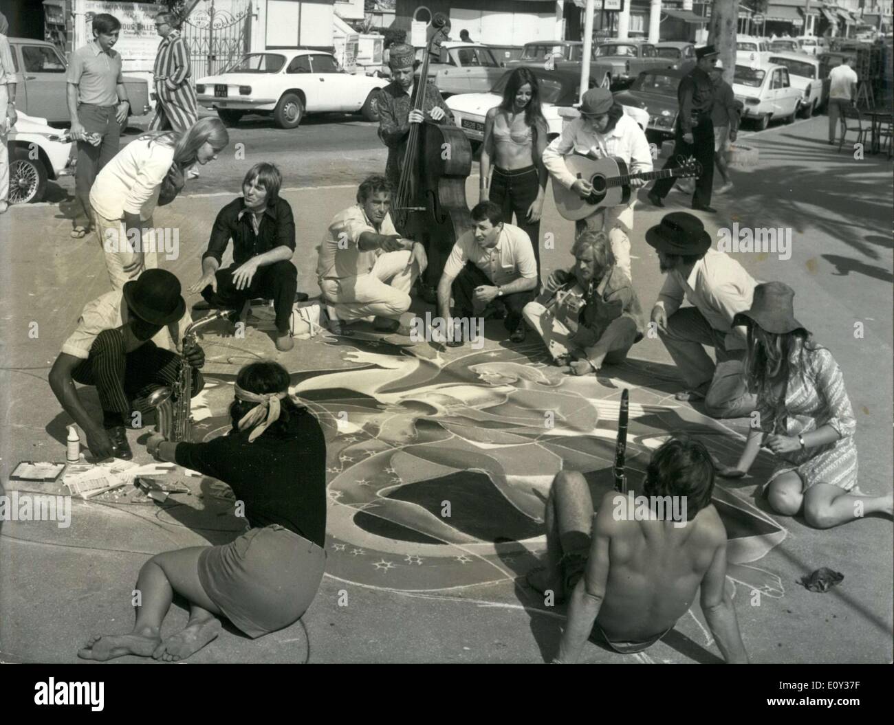 Sep. 14, 1968 - Raymond Moretti, a painter who is know all over the world, has abandoned his luxurious career to paint on the sidewalks of Juan-les-Pins. He is doing it for a movie called ''Le Temps Fou'' that Marcel Camus is currently filming on the French Riviera. Surrounded by beatniks and hippies, Raymond Moretti makes a drawing on the sidewalk in Juan-les-Pins. Stock Photo