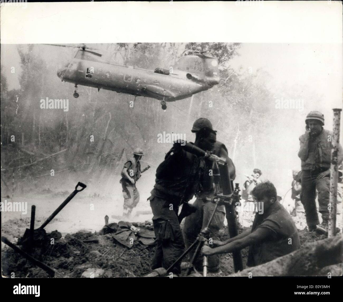 Oct. 07, 1968 - The War In Vietnam Marines In Mortar Battle: This graphic picture from the war in Vietnam, shows American Marines as they opened fore with 8lmm mortars to suppress enemy mortar fire on their position. Behind is a transport helicopter taking off her clear from incoming shells. Stock Photo