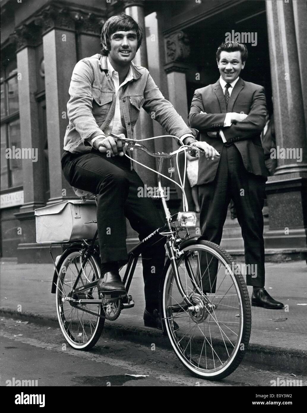Jul. 07, 1968 - George Best - Banned From Driving For Six Months - Is Presented With A Bicycle: Banned from Arriving for six months by a Manchester court, Manchester United's ''Footballer of the Year'' George Best, is unperturbed. Yesterday he was presented with a bicycle to solve his transport problems. George received the cycle prior to a training spell at Old Trafford ground, and he rode up and down amongst the traffic to get used to the feel of his new machine. There is a large bag at the back for carrying his boots or anything else., such as fan mail Stock Photo