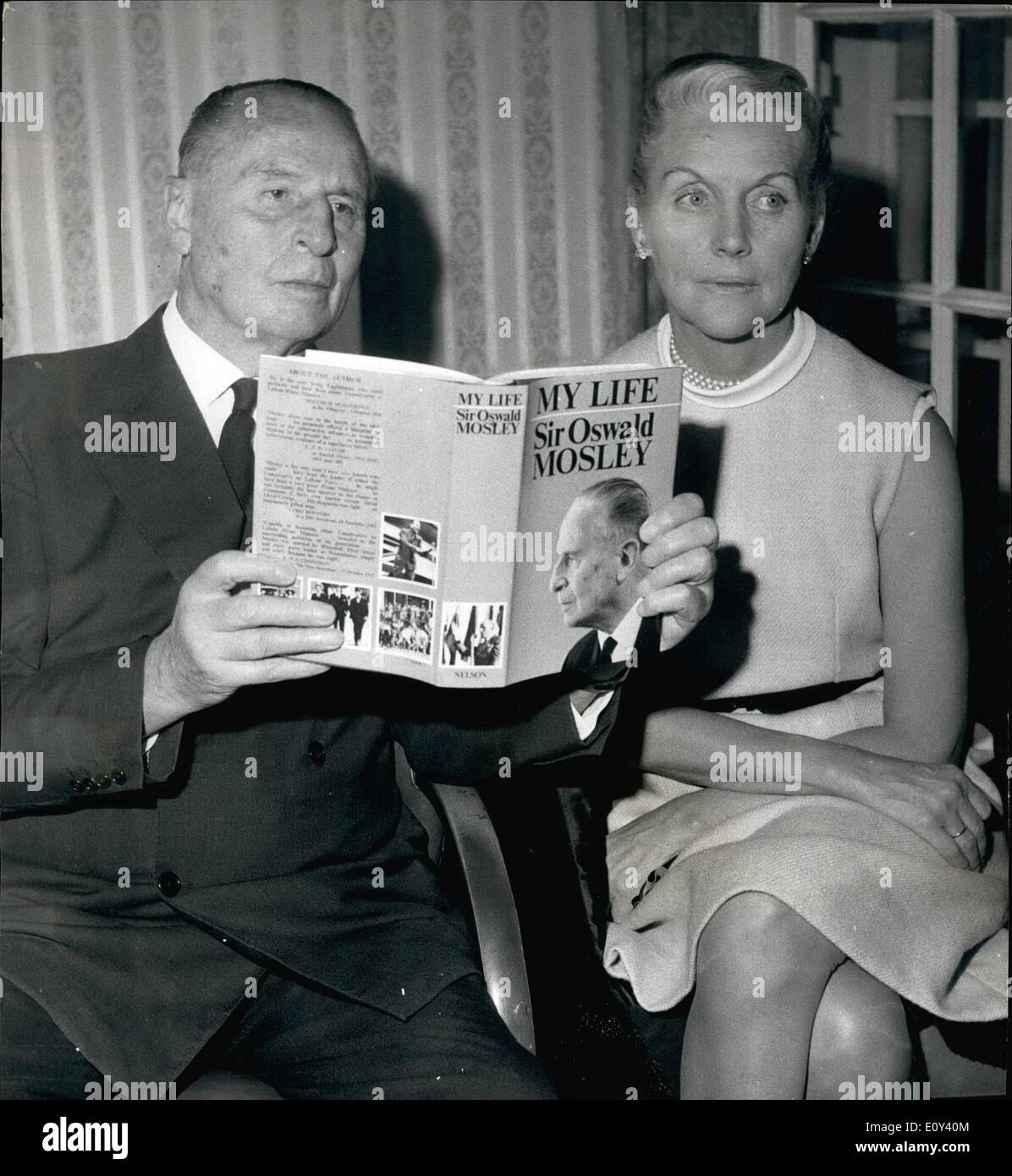 Oct. 10, 1968 - Sir Oswald Mosley Hold Press Conference to Launch his Autobiography ''My Life'': Sir Oswald Mosley, the one time leader of the Blackshirt.Movement in Britain, pictured with his book ''My Life'' as he poses with his wife at the press conference held at the Cafe Royal to launch his book this opening. Stock Photo