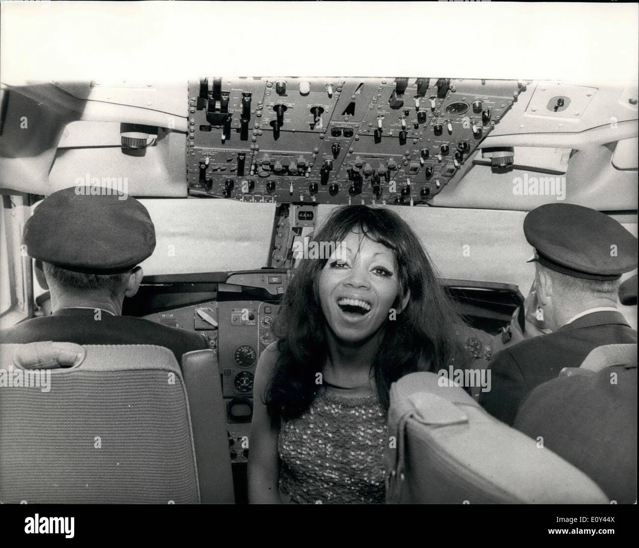 Jul. 07, 1968 - Plane Flight To Promote New Record By Chris Rayburn: To promote the new recording by 23-year old Chicago born Chris Rayburn, she made a special flight from Gatwick Airport today round the South and East coast of England, in a plane chartered by the record company, MGM, during which the record, called ''One Way Ticket'' was played. Chris Rayburn wore a red trouser suit by Clive. Photo shows Chris Rayburn pictured in the cockpit of the plane with the pilots - today. Stock Photo