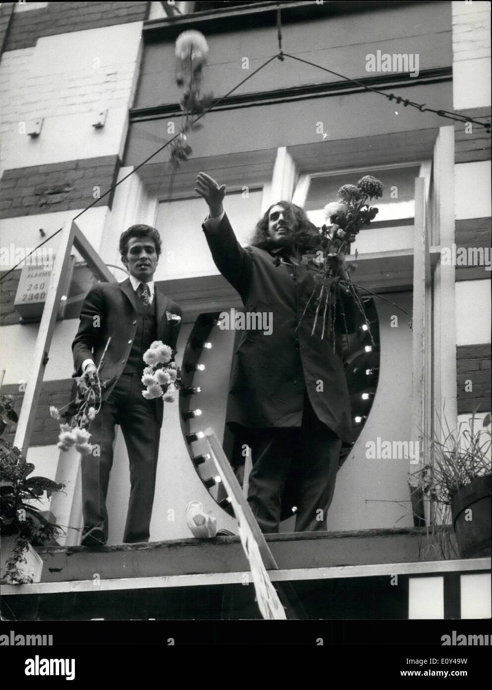 Oct. 10, 1968 - Tiny Tim - The six foot plus American Pop star visits London's famous Carnaby Strip: Tiny Tim, the six foot plus American Pop star who sings like a choir boy, has arrived In London for several engagements. He is ready to be earning 500,000 dollars a year in U.S Tiny Tim admits he wears make up During Show time, powders his skin fifteen time and takes showers all through the day. Photo shows Tiny Tim throws flowers from the balcony of John Stey's Drug Store when he Paid It to London's a famous Carnaby today. Stock Photo
