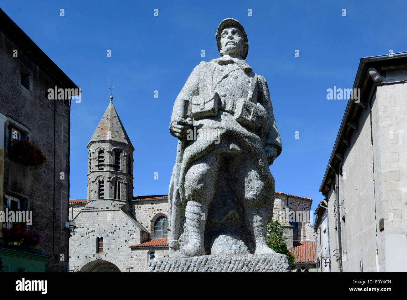 War memorial and church in the village of Saugues, Gévaudan, Haute Loire, Auvergne, France, Europe Stock Photo