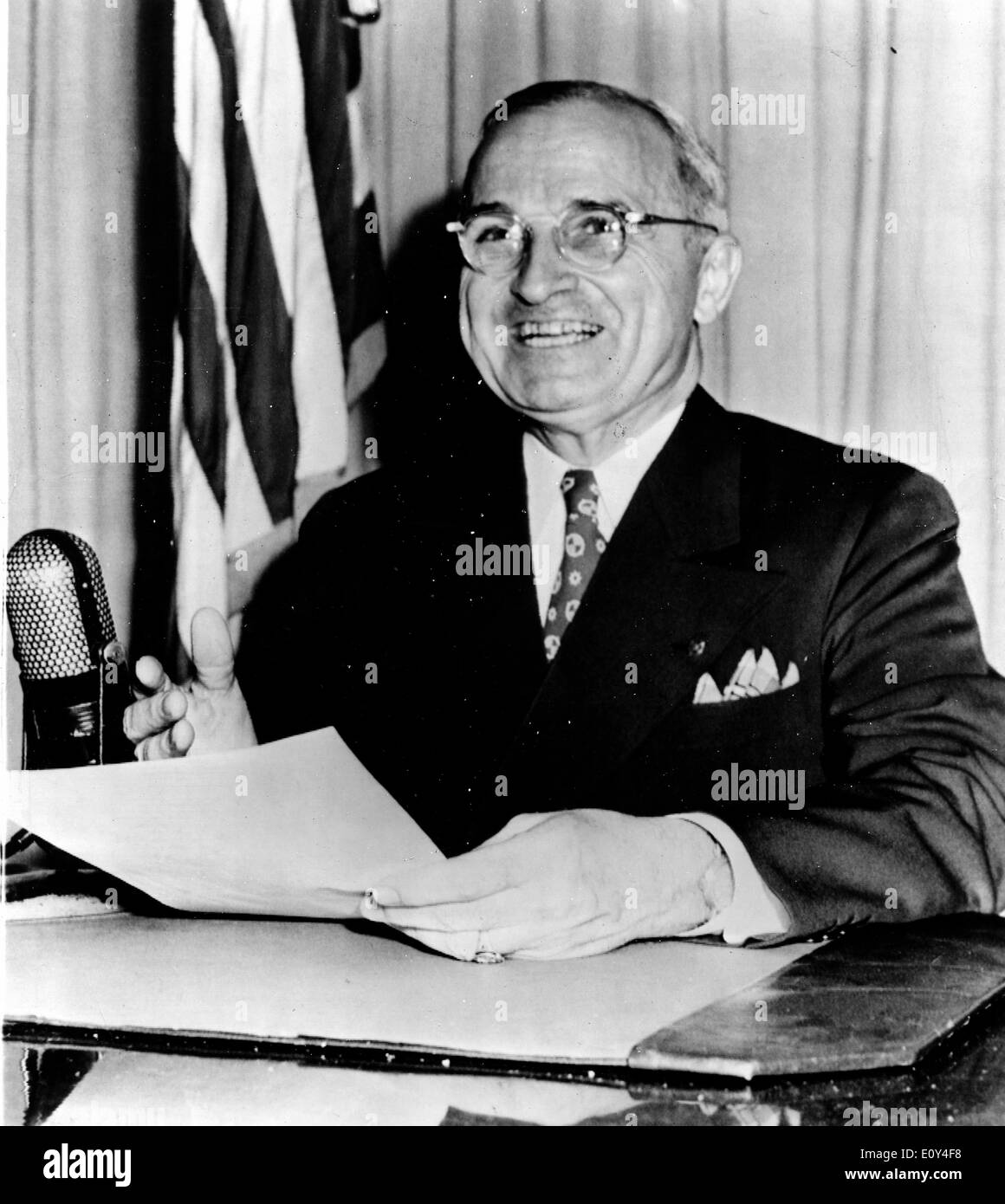 President Harry S. Truman talking from desk Stock Photo