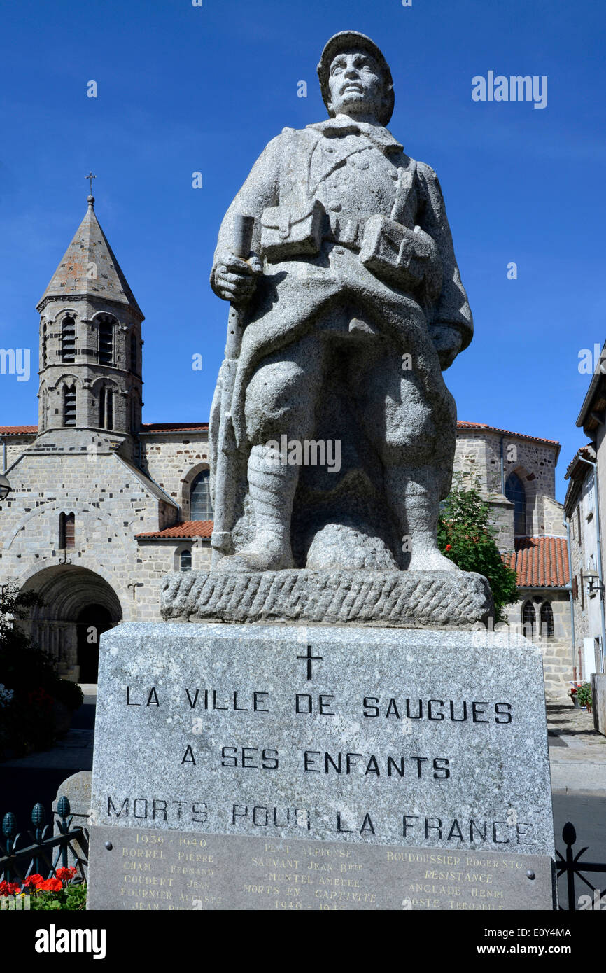 War memorial and church in the village of Saugues, Gévaudan, Haute Loire, Auvergne, France, Europe Stock Photo