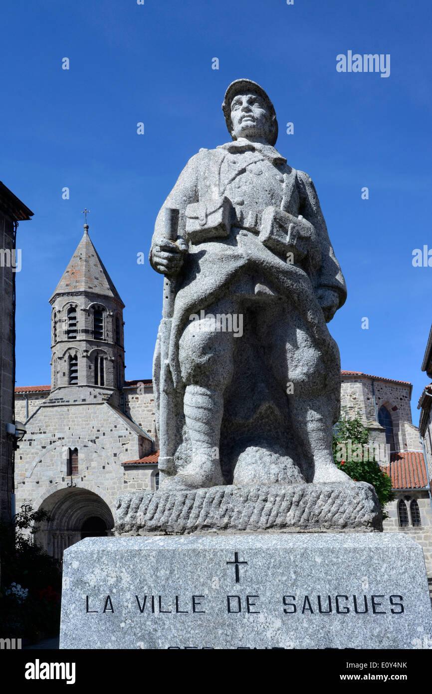 War memorial and church in the village of Saugues, Gévaudan, Haute Loire, Auvergne, France, Europe Stock Photo