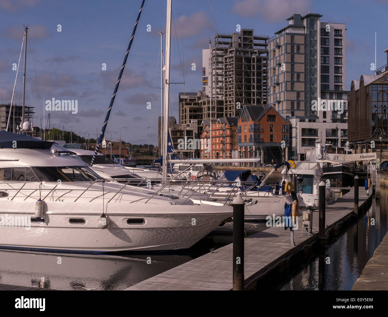 Luxury yachts in Neptune Marina with high rise developments beyond, Ipswich, Suffolk, UK Stock Photo