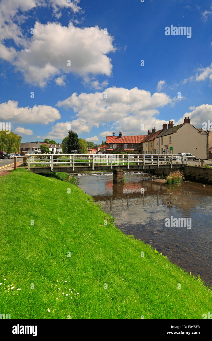 Wooden footbridge over the River Leven in Great Ayton, Low Green, North Yorkshire, England, UK