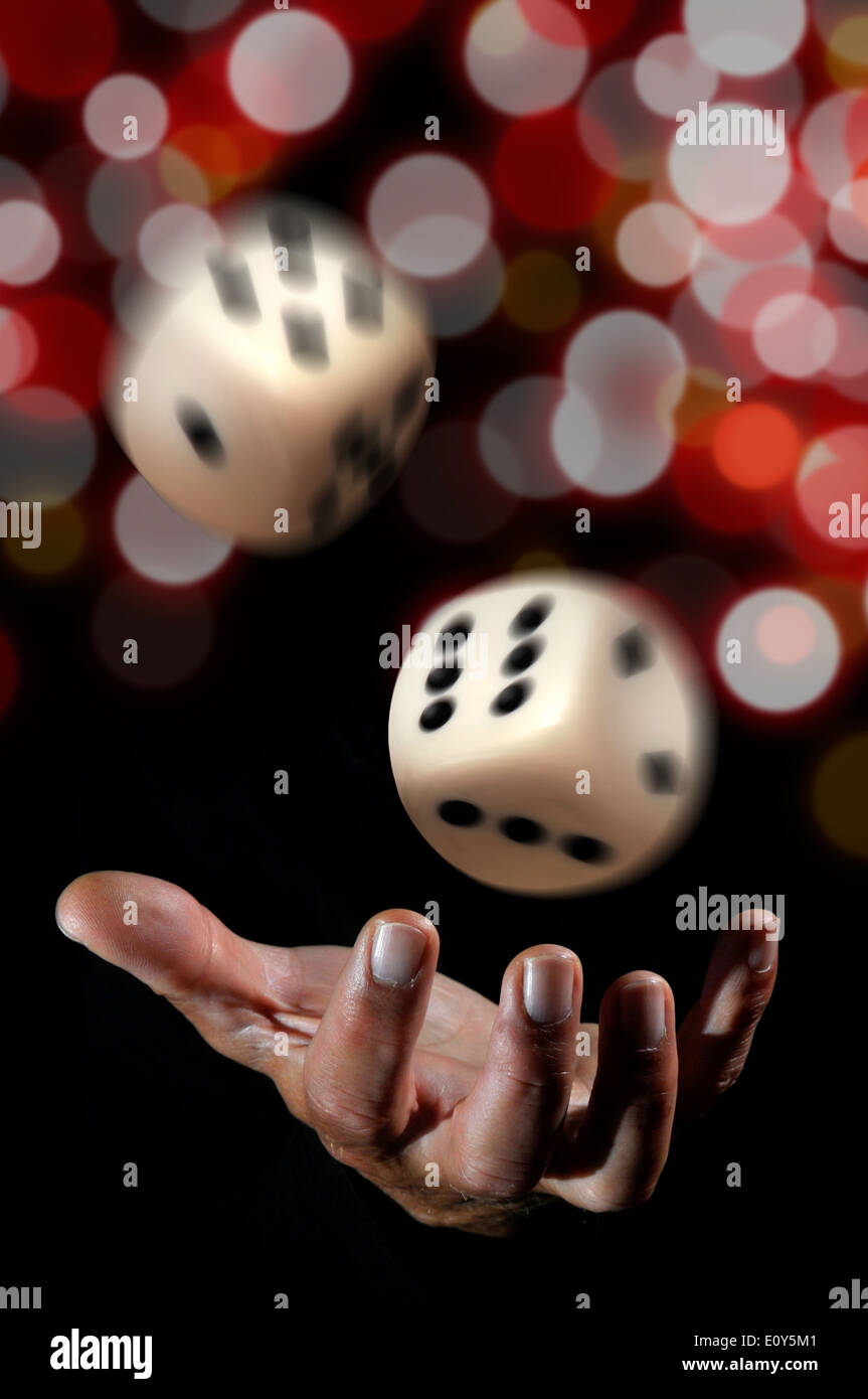 Hand throwing dice in a dark background Stock Photo Alamy
