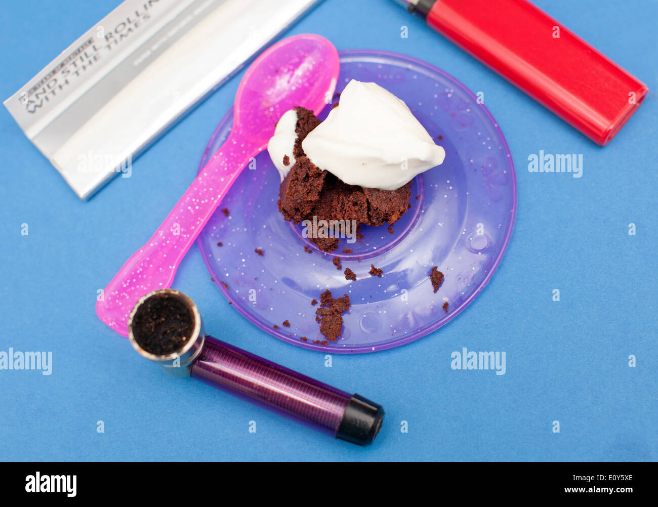 Hash Brownie or Space Cake topped with creme fraiche framed by smoking paraphernalia, London Stock Photo
