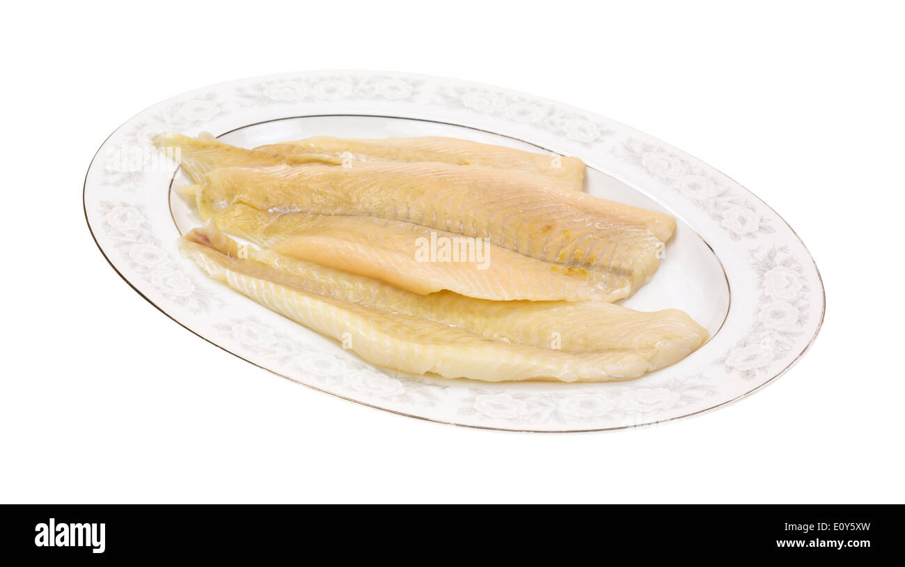 Several fresh flounder fillets on an old serving platter. Stock Photo