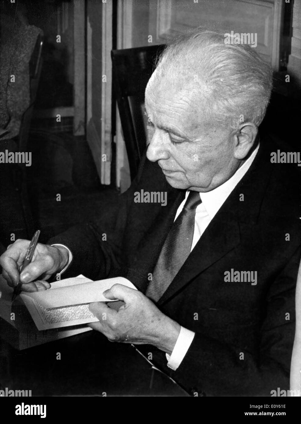 Dec 02, 1968; Paris, France; The annual sale of books by the authors was held at Palais D'Orsay in Paris, yesterday. The proceeds of the sale sponsored by the National Committee of Writers go for the benefit of needy members. The picture shows the famous poet LOUIS ARAGON autographing his books during the sale. Stock Photo