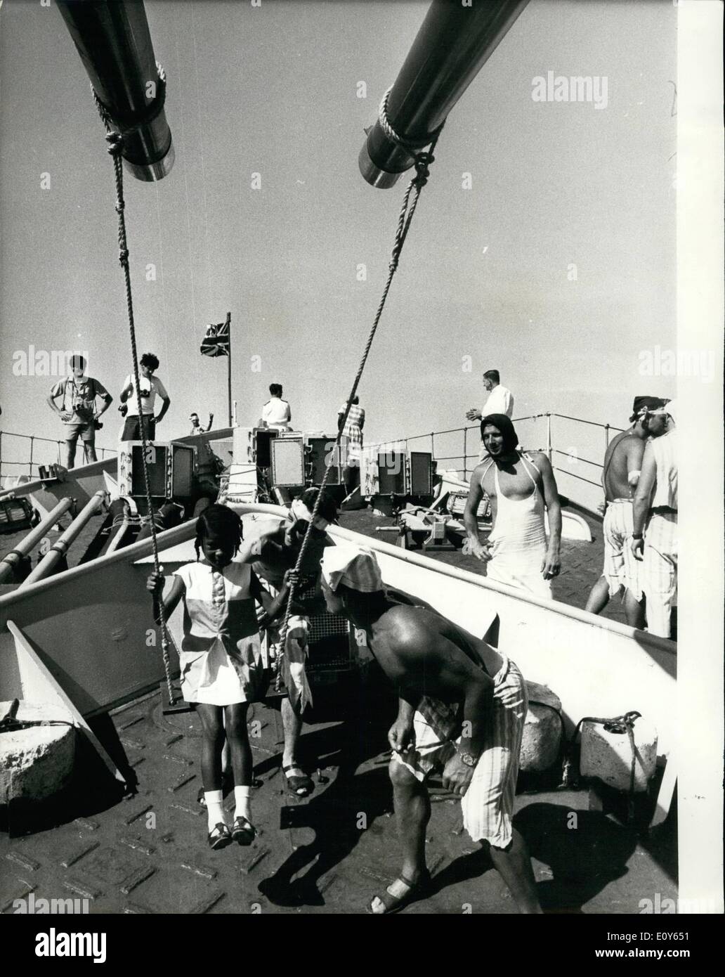 Mar. 03, 1969 - Navy ''Pirates'' Put On A Swinging Party For Young Anguillans: Navy men in pirate costume see that nine-year-old Sandra Vanterpool has a swinging time at the party given on board by the ship's company of the frigate HMS Minerva last Monday for children of Anguilla, where the Minerva is serving with the British forces. The swing is suspended from 4.5in. guns of the frigate. Stock Photo