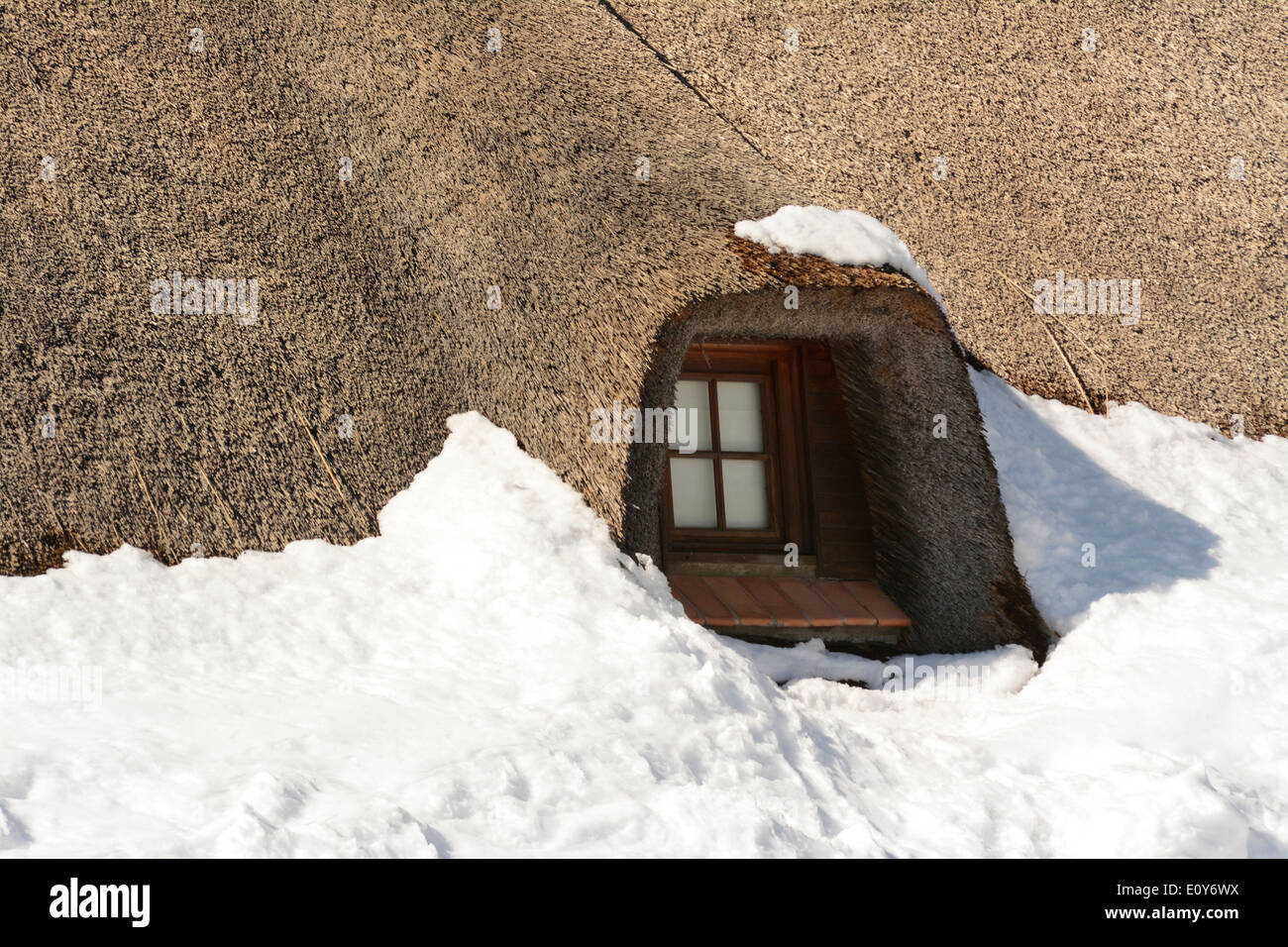 Dormer window in a thatched roof on a house Stock Photo
