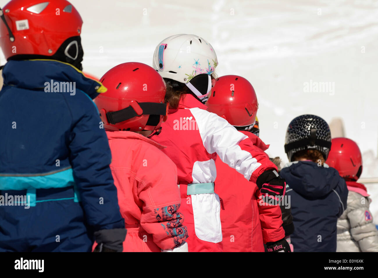 Children learning to ski at a ski resort, France - waiting in line at a ski school Stock Photo