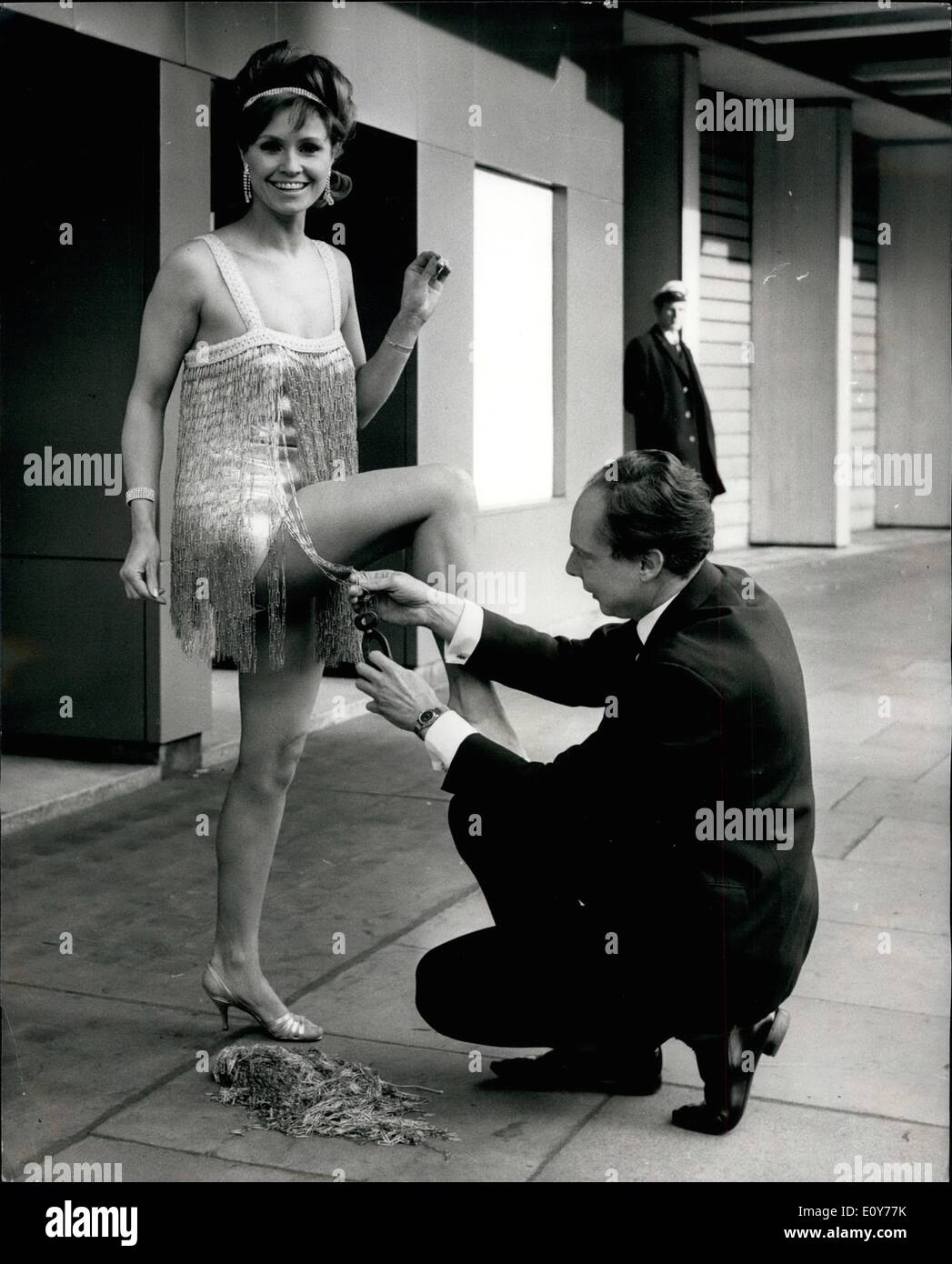 Jan. 01, 1969 - How Many Paperclips Make A Mini-Shimmy Dress?: 24-year old Barbara Smith, former Miss Britain and now a TV and film actress, knows how many thousands - she has to wear it! - but visitors to Statinex ' 69, the stationery industry's exhibition which opens at Olympia tomorrow (Jan 27) - will be asked to judge the number for a competition held in conjunction with the exhibition. The dress - the miniest shimmy to grace the 1920's - is a cascade of paperclip chains topping a silver sheath. Barbara lives at Woodford Green, Essex Stock Photo
