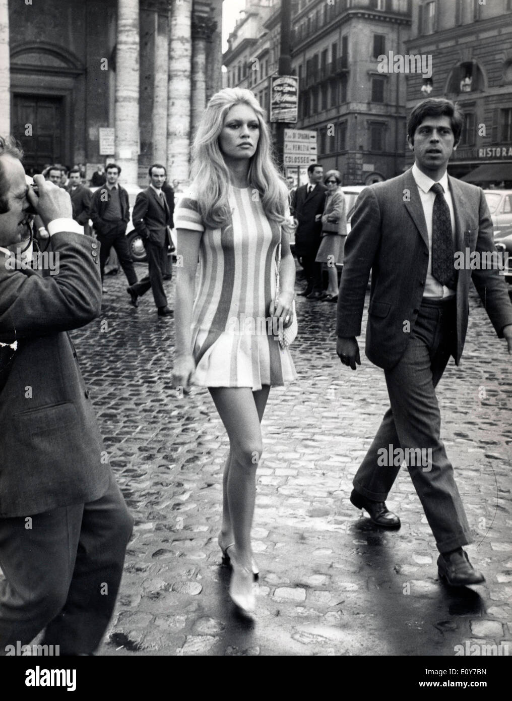 Actress Brigitte Bardot walking through streets Stock Photo