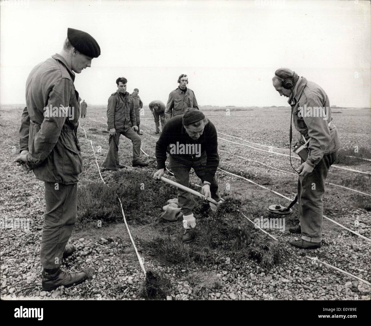 Jan. 27, 1969 - Ex-P.O.W.'s ''De-Fuse' Bird Sanctuary: Former prisoners of war, from Germany and the Ukraine, are helping to make a Kentish beach free from the dangerous relics of war training. Denge Beach, near Lydd, is to be a bird sanctuary when all the material of war is discovered and destroyed. Under the supervision of N.C.O.'s of the Royal Engineers Bomb Disposal Unit, they are going yard by yard over taped sections of the foreshore, recovering dangerous eroded shells and mortar bombs Stock Photo