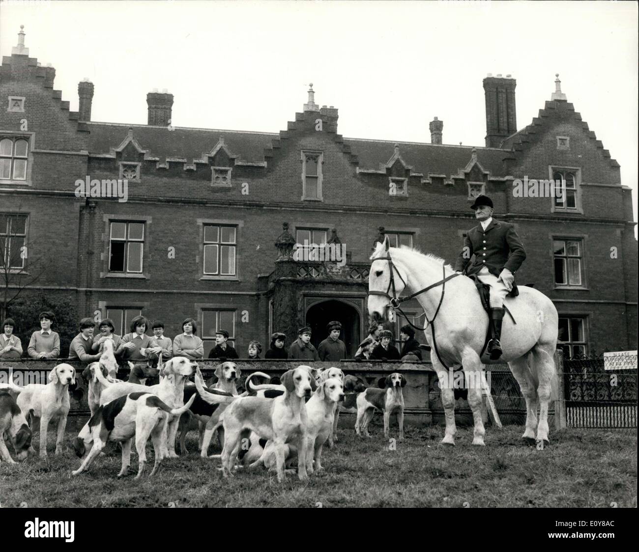 Feb. 01, 1969 - The Enfield Chace Foxhounds move off from Broxbourne School Herts ? The Enfield Chace Foxhounds meet this morning at the Broxbourne School for Girls in Broxbourne, Herts, giving the pupils a grand opportunity to see the colourful turn-out of the hunt meet. Photo Shows: A general view of the hunt before it moved off this morning with the Broxbourne School in the background, and a line of girls from the school looking on. Stock Photo