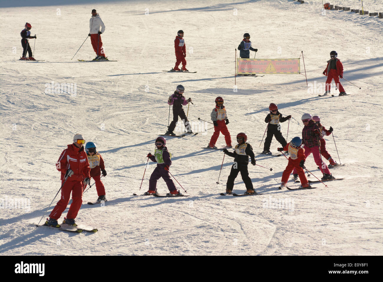 Children learning to ski at a ski school at a ski resort Stock Photo