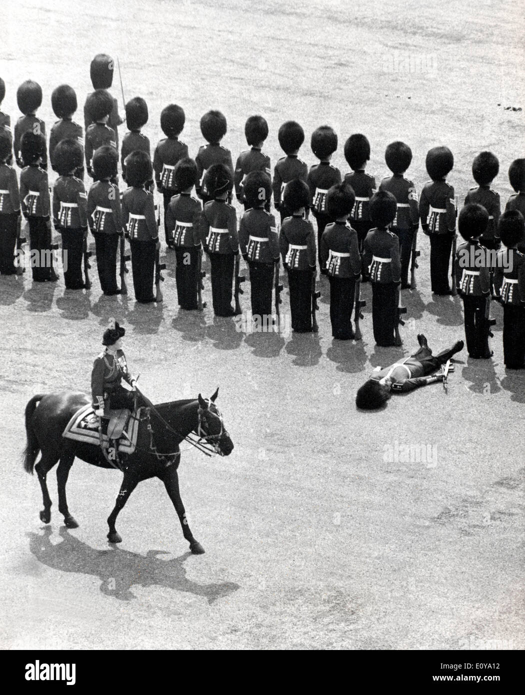 Queen Elizabeth II watches fainted guardsman Stock Photo