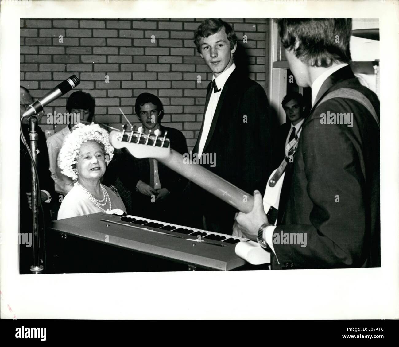 Jul. 07, 1969 - Guitar Serenade For Queen Mother, is seen at the Hitchitn, Hertfordshire, Youth centre today, July 4, being serenaded by Keith Ruff, 18, and his youth band. The Queen Mother made a long tour of the centre taking a great interest in the many activities for young people. Stock Photo