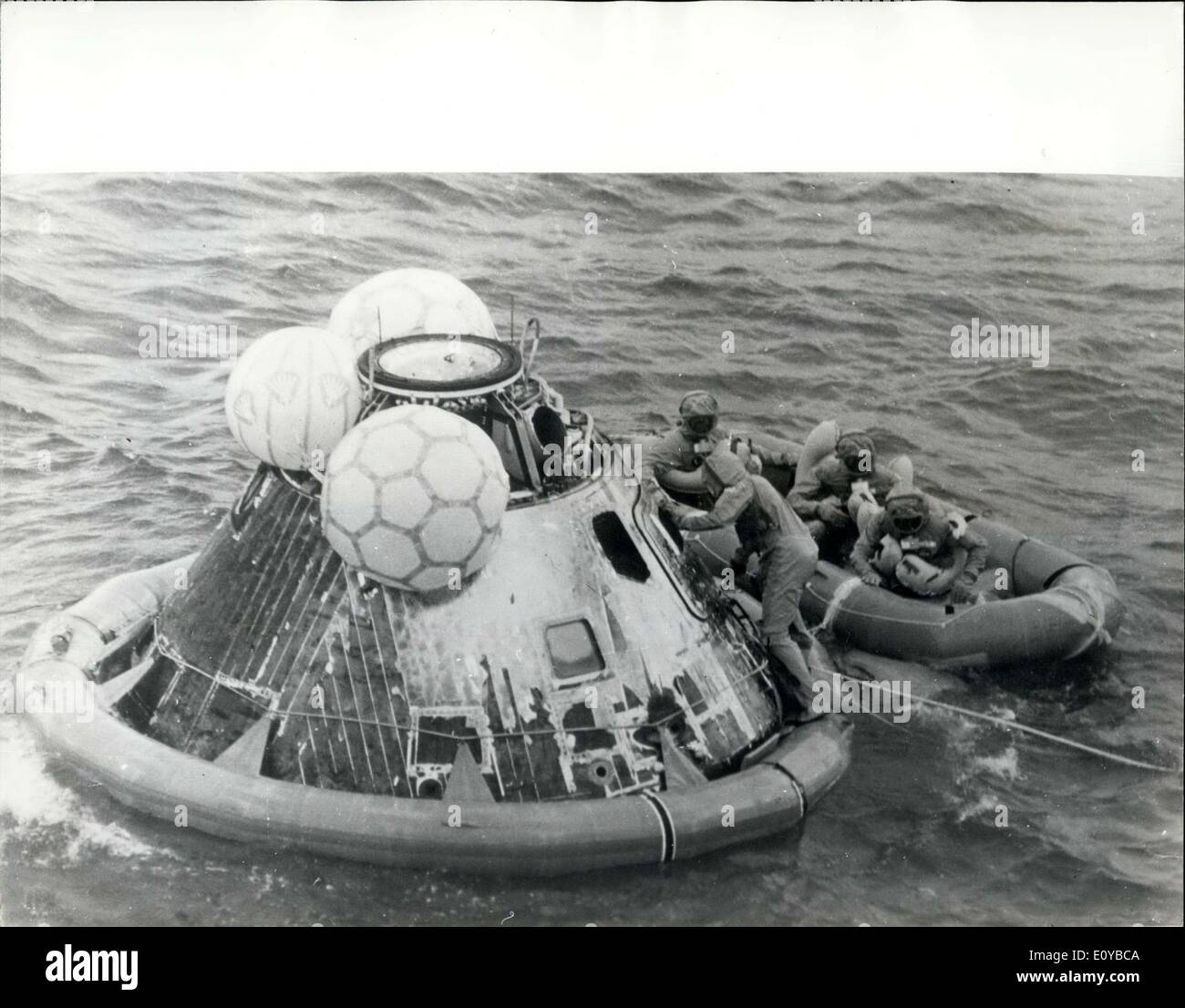 Jul. 29, 1969 - Apollo 11 Splashdown: The Apollo astronauts watch pararescuemen Lt. Clancey Hatleberg close their spacecraft's hatch following splashdown in the pacific ocean on July 24th,1969. 900 niles southwest of Hawail, Astronauts Neil Armstrong, Michael Collins and Edwin Aldria were flown by helicopter to the USS Momot, prime recovery ship, where they entered their Mobile Quarantine Facility. Armstrong and Aldrin conducted man's first exploration of the lunar surface. (The three inflated bags repositioned the spacecraft upright after it had turned over after splashing down. Stock Photo