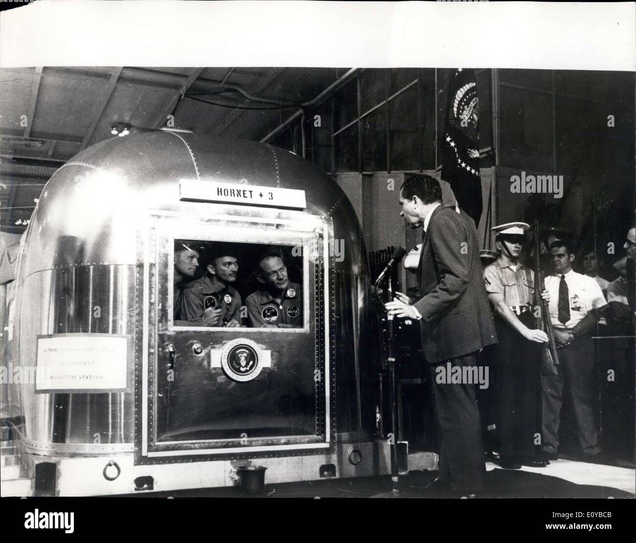 Jul. 29, 1969 - Apollo 11 Splashdown: The Apollo 11 astronauts,(L to R ) Neil Armstrong,Michael Collins and Edwin Aldrin, listen to greeting by president Richard M.Nixon from inside their mobile Quarantime facility aboard the USS mormet. The president used a micro phone to speak to the lunar explorers after their recovery from the pacific ocean, 900 miles south west of Hawaii. Their quarantine trailor was off-loaded in Hawaii and flow aboard an aircraft to the manned spacecraft center in Houston, Texas Stock Photo