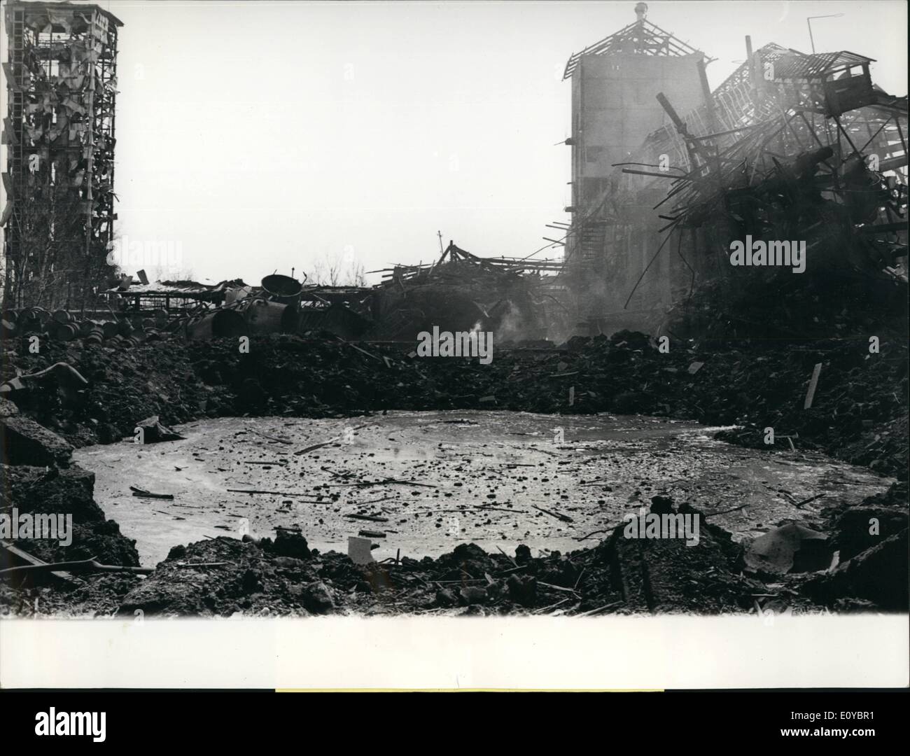 Aug. 08, 1969 - Explosion in a blasting-powder factory cause 9 deads and 40 injured: Tuesday morning, a few minutes after the clocks announced the beginning of the work, the ''Federal explosive-factory'' in Dettiken, canton Aargau, was nearly totaly destroyed by a terrible explosion. The causes for this catastrophy are not known up to now. At least nine workers have been killed and about 40 injure. Four are still missing. The explosion wave has been resented even 20 km far from the center! Photo shows the very center of the explosion. A deep, 40 m large crater resulted. Stock Photo