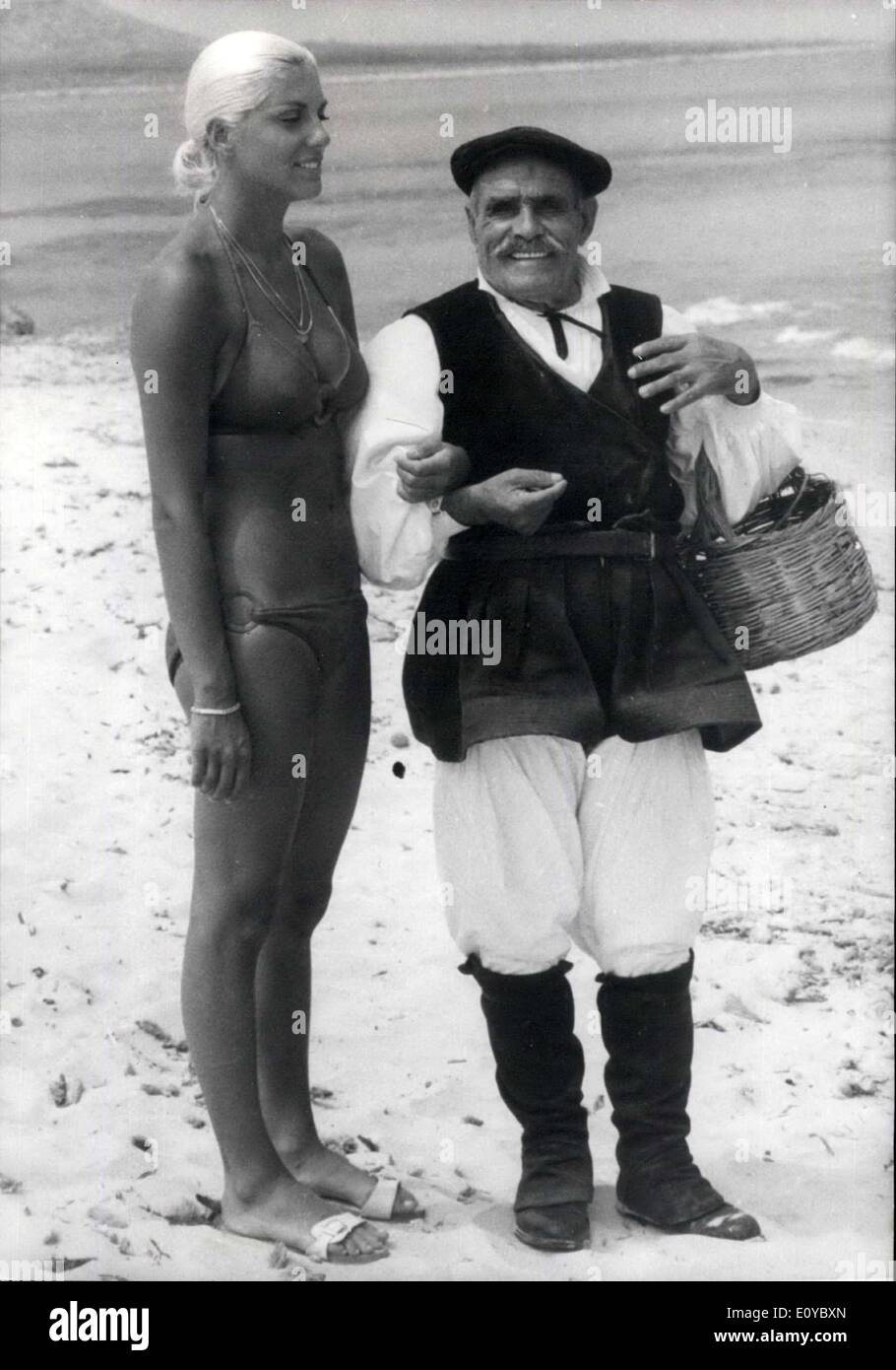 Oct. 17, 1969 - 88-year0old Sardinian as ''Kiki'''s Chaperon: Christine Caron, former French Girl swimmer No.1, is starring in the film ''Le Lis De Mer'' (Sea Lily) now in the making in Sardinia. Photo shows ''Kiki'' pictured with her ''Chaperon''. An 88-year-old Sardinian Benito Colombo. Stock Photo