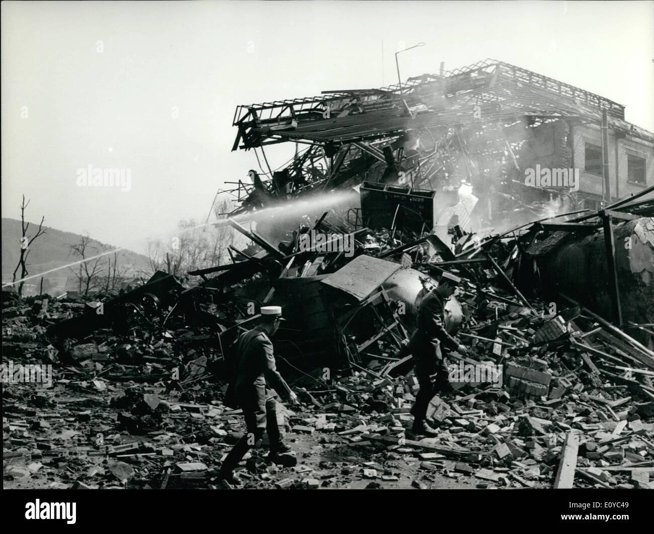 Aug. 08, 1969 - Explosion in a blasting-powder factory: 9 dead's and 40 injured: Photo Shows firemen cooling down the wracks heated by the explosion, Policemen searching for victims. Stock Photo