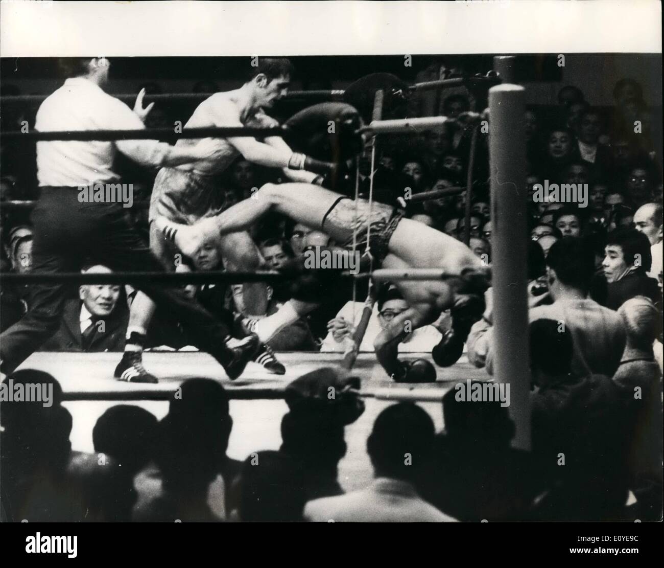 Jan. 01, 1970 - Famechon retains world title. Johnny Famechow of Australia retained his world feather weight in Tokyo on January 6th, when he knocked out fighting harada of japan in the 14th round. Photo shows Johnny Famechow punches harada through the ropes for the 14th. round knockout in Tokyo. Stock Photo
