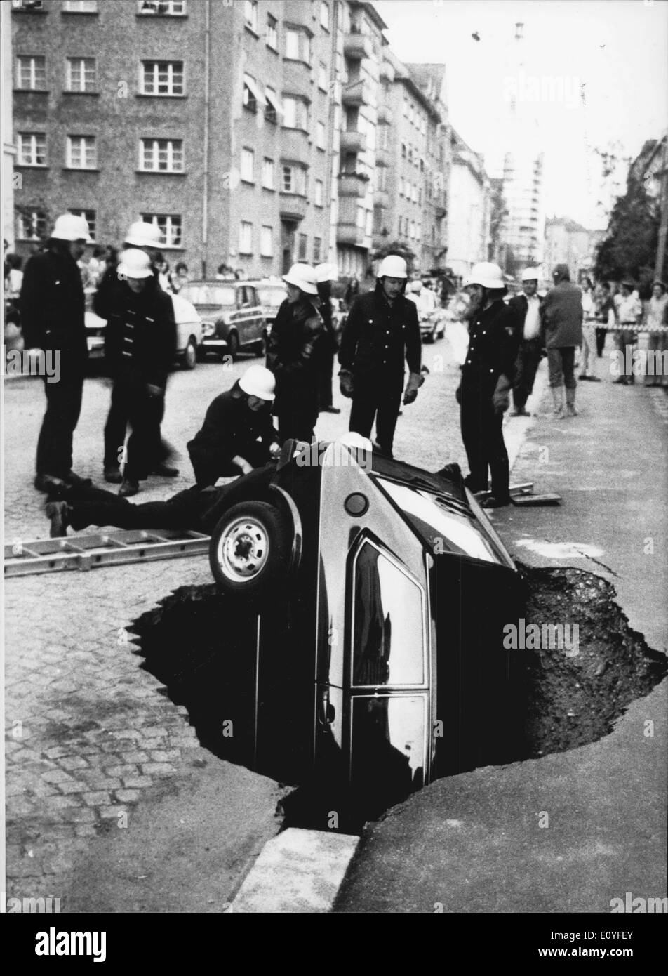 Jan. 1, 1970 - Gone into the ground: ... is this car - it happend in Munich/West Germany during a thunderstorm some days ago, in the Munich district Schwabing this parking car slided into the ''underground''! In the meantime it is clear, why this could happen: a special bore for a new subway-line was not made correct to the instructions: by this water could come into the bore hole and the earth moved up. Fortunately nobody was injured by this incident. Stock Photo