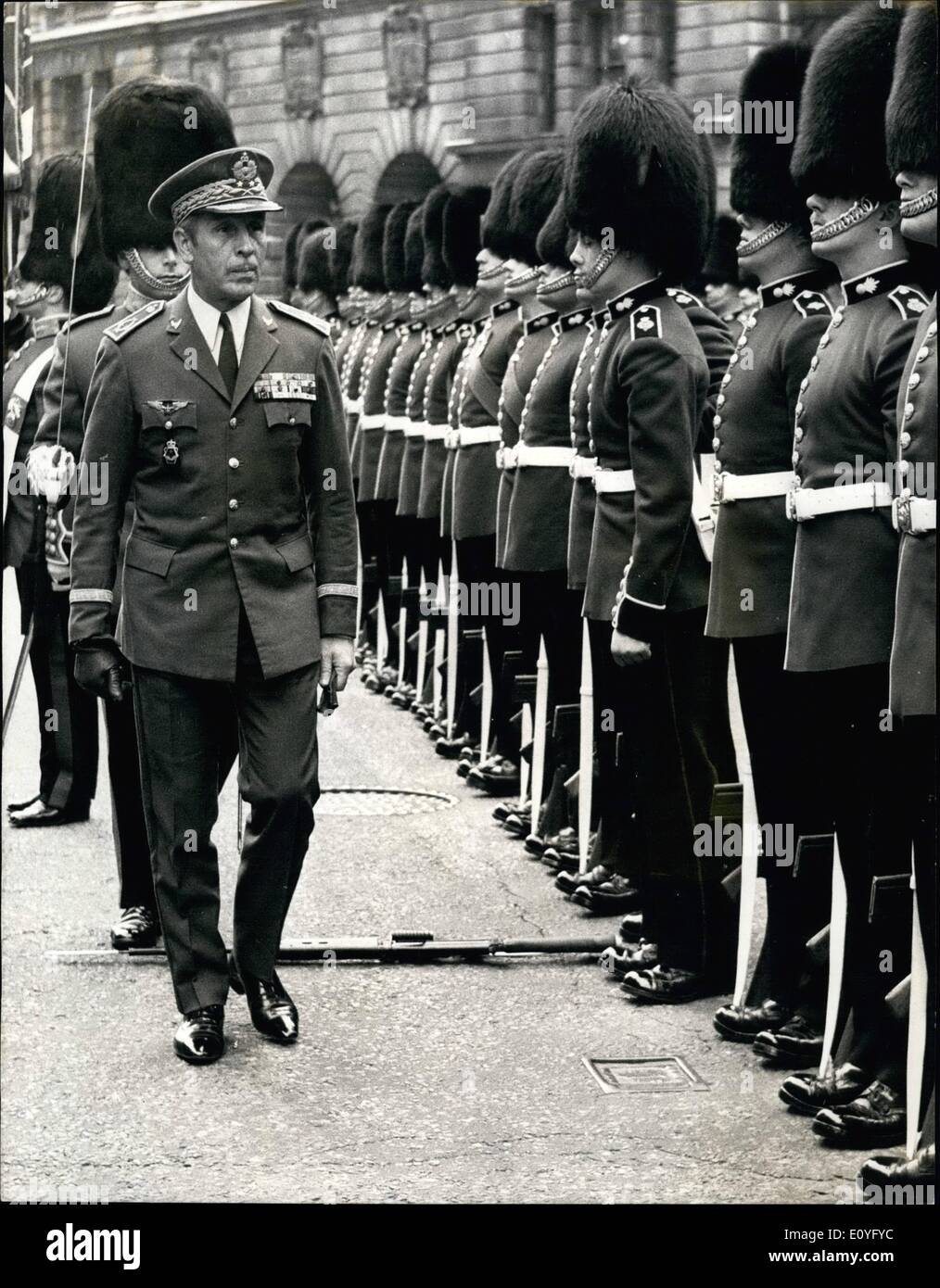 Apr. 04, 1970 - The Guardsman that dropped his rifle: During the inspection of the guard of honour by General De Brigade Drissem Nichi, Deputy Chief of the Defence Staff and Commander of the Royal Moroccan Air Force, outside the Ministry of Defence in Whitehall today, one member of the guard, provided by the 2nd. Battalion Grenadier Guards, nearly fainted and dropped his rifle. Photo shows As General De Brigade Driss  Michi inspects the guard of honour the guardsman sways forward and drops his rifle during a fainting spell. Stock Photo