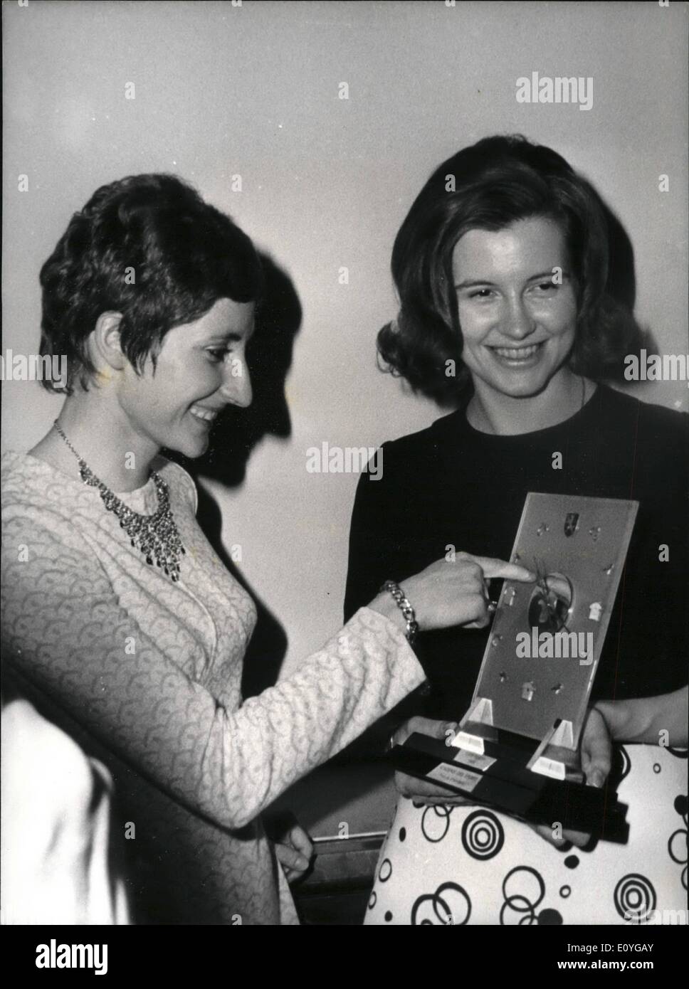 Apr. 04, 1970 - Eddy Merckx rewarded - wife gets award pro husband: Awards to the best athletes of the year where distributed by the Paris Sports Academy at the Automobile Club Headquarters yesterday evening. MME Merckx, wife of the famous Belgian cyclist deputised for her husband wjo was participating in the Annual Liege-Bostogne race. Photo shows MME Merckx (right) pictured with the trophy (a clock of great value). On the famous French girl runner Nicole Duclos who was awarded the Virginie-Herrior Prize. Stock Photo