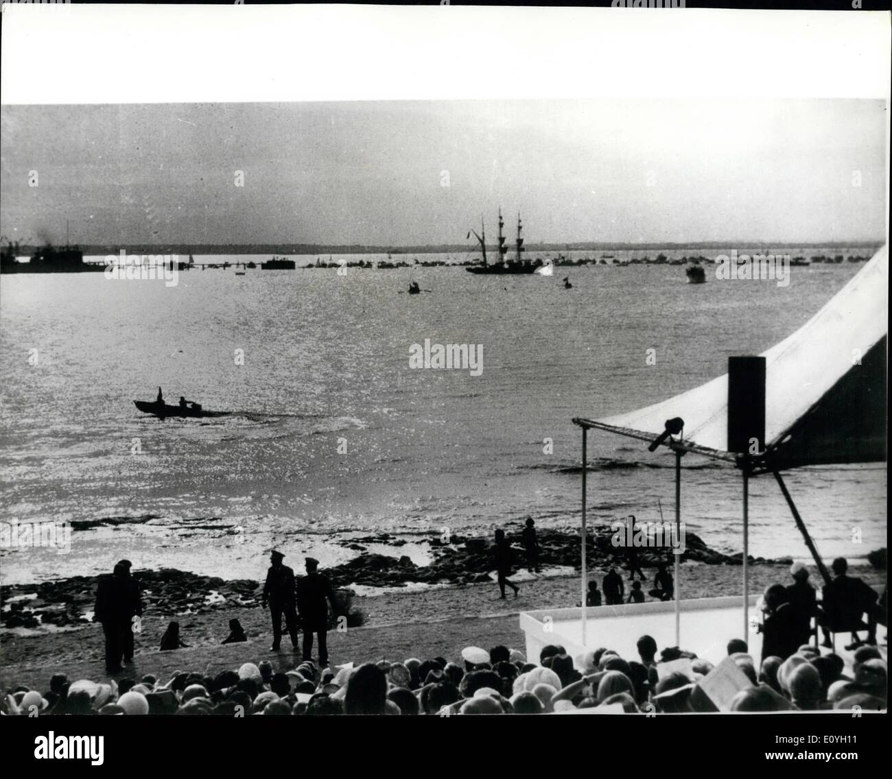 May 05, 1970 - Queen Watches Re-enactment of Captain Cook's Landing.: As the Royal Family waited to watch a re- enactment of Captain Cook's landing at Botany near Sydney, Australia pranksters in an outboard motor boat stole the show. Dressed in period costume two students raced for the shore carrying a Union Jack, chased by Police launches, and planted their flag before the official landing could get under way. The incident was watched by members of the Royal Family. Photo shows General view in Botany Bay as the students in the speedboat stole the show Stock Photo