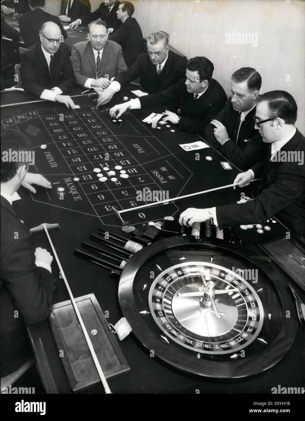 May 05, 1970 - Gaming board inspectorates training school at Leyton High road: A course for 21 gaming inspectors is now in progress at Leyton, East London. The object of the inspectors is to ensure that all regulations regarding gaming are observed in the Gaming Act. The inspectorsare undergoing a 15 week course studying ''Black Jack'' ''Roulette'' and ''Crapa'' etc. Photo shows a game of ''Roulette'' in progress by inspectors on right the ''Croupier'' is Mr. Paul Horne who was former club croupier. Stock Photo