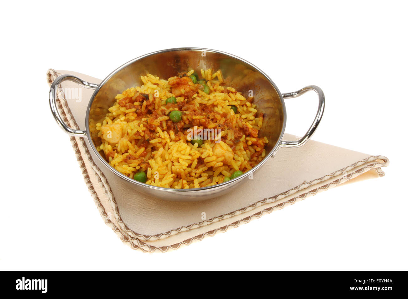 Lamb biryani in a balti dish on a seviette isolated against white Stock Photo